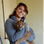 Dr. Condos smiling and holding a larger cat